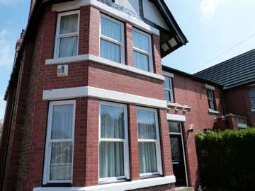 Moreton , Wirral - Installation of Whitewood PvcU Vertical sliding windows complete with black cill. Black Composite Front Entrance with triple glazed design leads